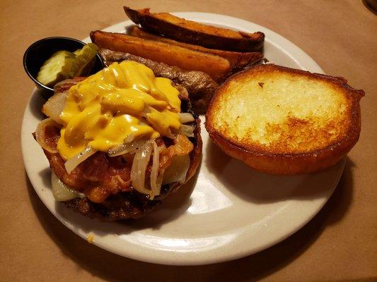 A whiskey burger and potato wedges.