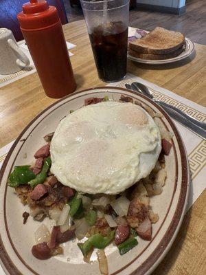 Polish Skillet (minus cheese): chunked kielbasa, bell peppers, onions, smashed red skin home fries & 3 eggs with 2 slices of toast.