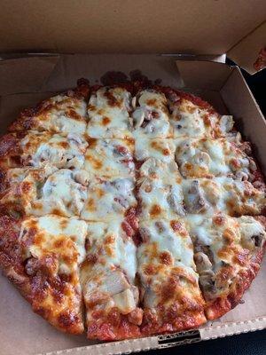 Thin crust sausage and mushroom pizza.