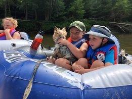 Young campers on tube on the river