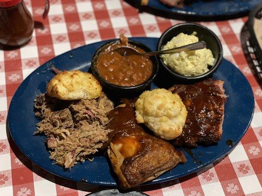 BBQ Bar - B - Que Combo (pulled pork, chicken, baby back ribs, potato salad and baked beans). Comes with 2 biscuits