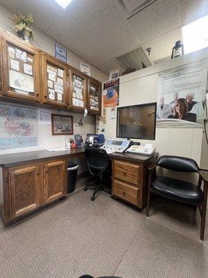 Inside office where interview was conducted with audiology equipment and sound booth in background