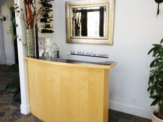 A beautiful bar in an upscale Folsom home has an inlaid granite countertop to serve guests at your next party in style.