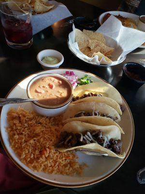 MAD Tacos, asada and fresh vegetables and avocado sauce.