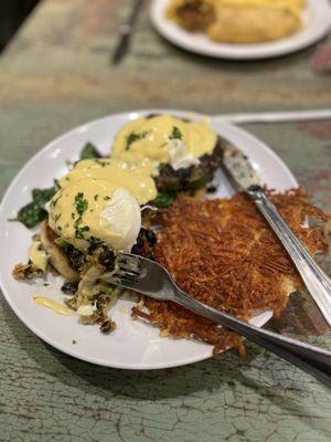 Eggs Benedict with black bean cakes and hash browns.