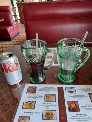 Drinks are served in glass Coca Cola mugs.