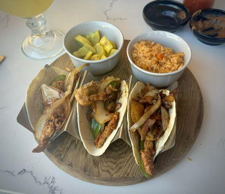 Campiranos artisan tacos with veggie and rice sides.