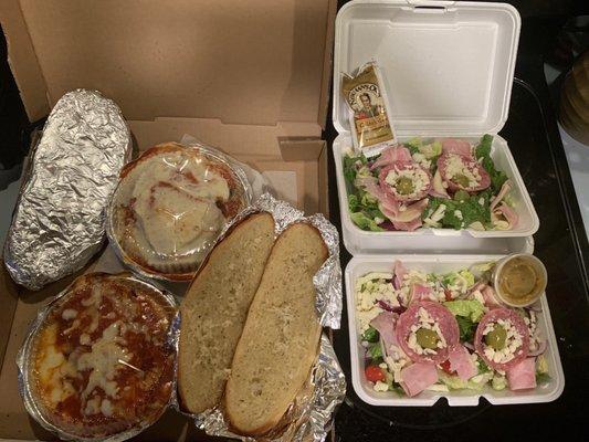 Lasagna, chicken parm, 2 orders of garlic bread and their side salads