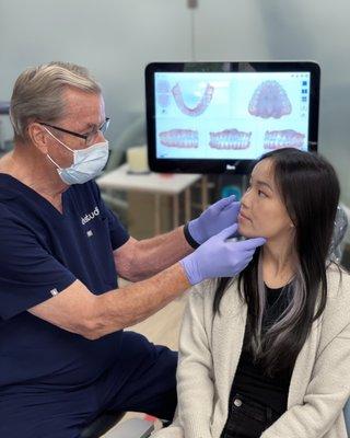 Dr. Redmond shows this patient how her jaw will adjust once her InBrace treatment is complete.