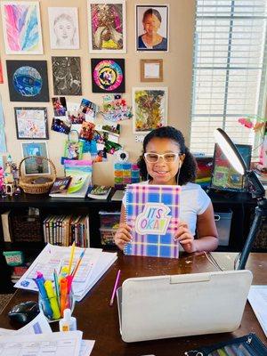 Toni with her Art Wall behind her.