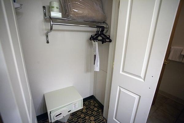 Behind the bathroom sink, a closet for hanging clothes and a safe