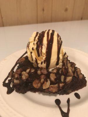 Warm Brownie pecan pie  served with ice cream