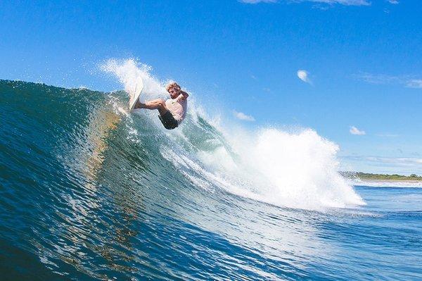 Lee Mierowitz Off the lip on our Throwback twin fin glass on surfboard