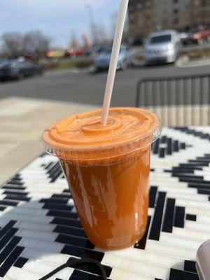 Carrot/apple/ginger juice blend on the patio