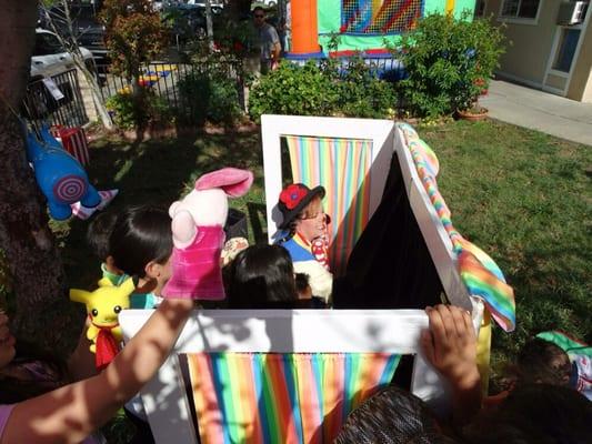 She gets the kids involved in the puppet show