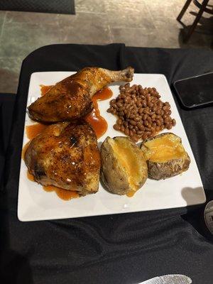 Chicken, baked potatoes and baked beans.