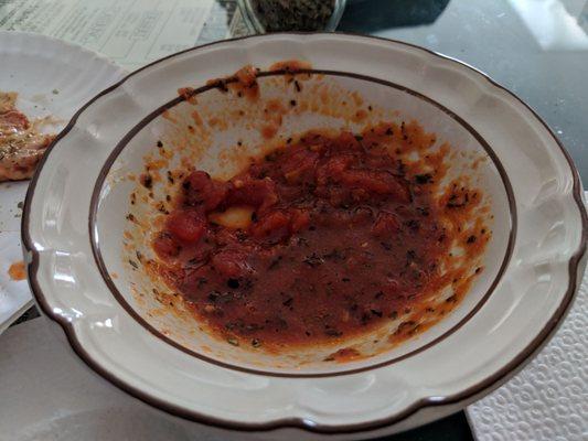 What's left of the tasty homemade dipping sauce for the stuffed pizza.