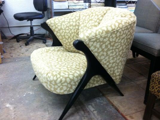 Antique contemporary chair with wood legs refinished in satin black and animal print fabric