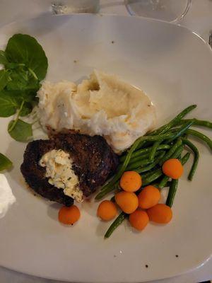 Pork chop with apple cherry chutney, garlic mashed potatoes and vegetables .