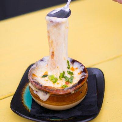 French Onion Soup au Gratin | caramelized onions, rich beef broth, toasted garlic croustade, swiss & provolone cheeses