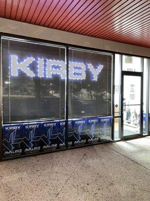 Front KIRBY window sign lighted.