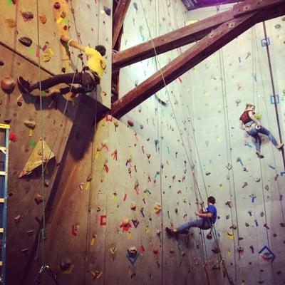 Staff members at Tally Rock Gym set new routes on the climbing walls.