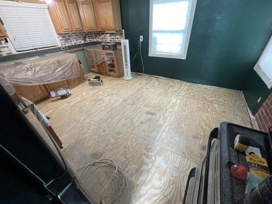 After replacing rotten joists with new joists and put new subfloor down. We had to remove the kitchen cabinets and also put those back down