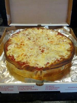 Whole stuffed pizza for take out order. Topped with sauce and cheese. This is how pizza is supposed to be made.