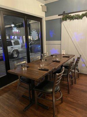 Main dining room feature table near the street windows! Super cozy. Right next to the bar.