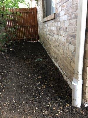 Back yard, side of hose, in ground drain system.  Also, ties in gutter and directs water to the back alley (no longer in our house)...