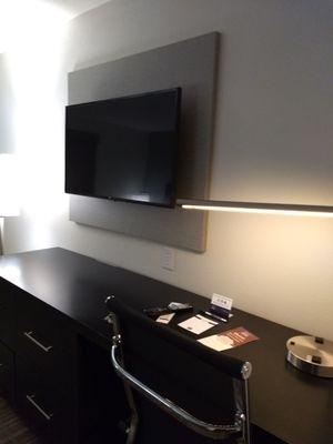 Desk/dresser combo, with wall mounted flat screen.