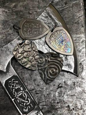 Our custom forged Raven axe and several pendants.