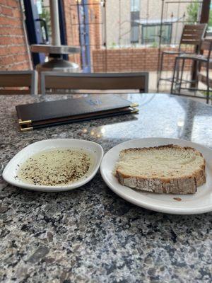 Sourdough blend bread and oil with cracked black pepper