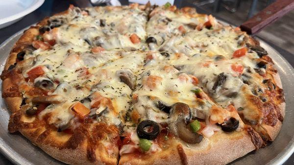 Medium veggie pizza fresh out of the oven