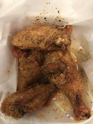 Five Lemon Pepper wings in oily looking sauce