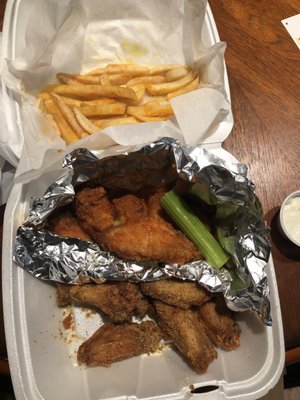 Lemon pepper and hot wings with fries to-go