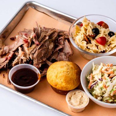 Pulled pork meal with Mediterranean pasta salad, cole slaw, and a cornbread muffin