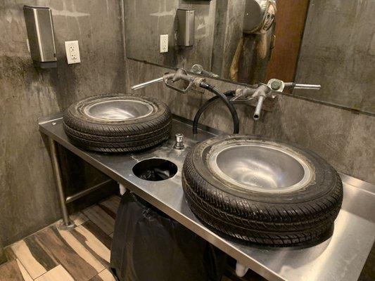 Men's restroom sinks are tires and gas pumps!