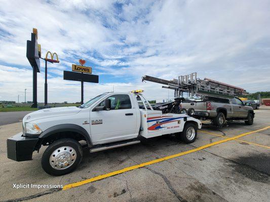 This truck usually has more ladders than that on it hard workers needing help