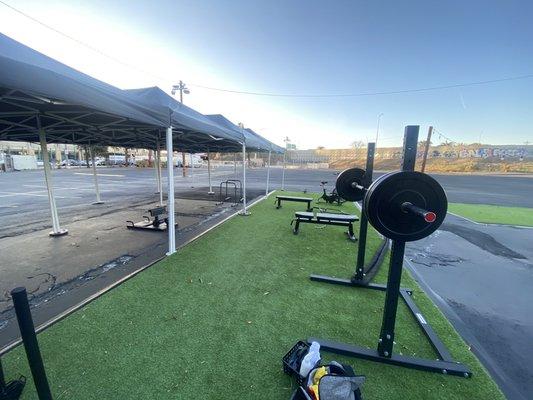 Open gym area with squat rack and two benches