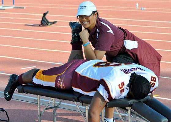 Dr. Cheryl working on one of her football players.