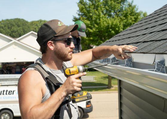 Larson & Keeney Contractor Installing a New Gutter System