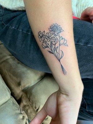 Fine line birth flower tattoo by artist Tiffany