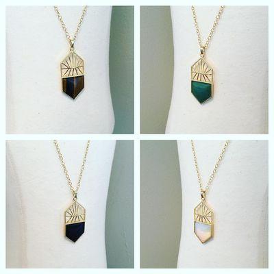 We carry a variety of pendant necklaces! These have a gold geometric pattern combined with various stones and gems.