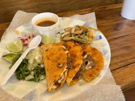 Quesobirria and a chicken taco. Just as the delicious red and green sauce.