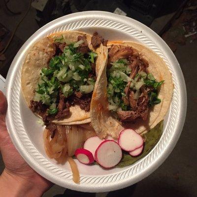 One asada (beef steak) taco and one carnitas (slow-cooked pork) taco.