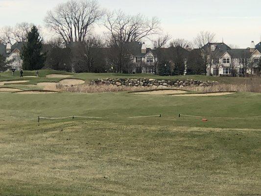 There's water between the traps and the rocks. It's about a 170 yard shot to the pin uphill