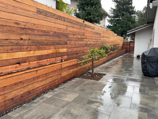 Side part of yard with new fence and pavers