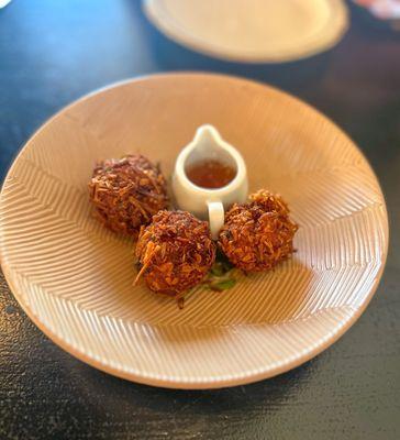 Coconut Prawn Croquettes: baby prawn & potato croquette, coated in coconut, served with mirchi pani (a light, spicy sauce)