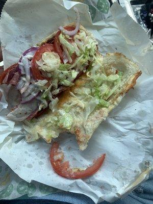 Spicy meat with lettuce, tomatoes, and red onion.